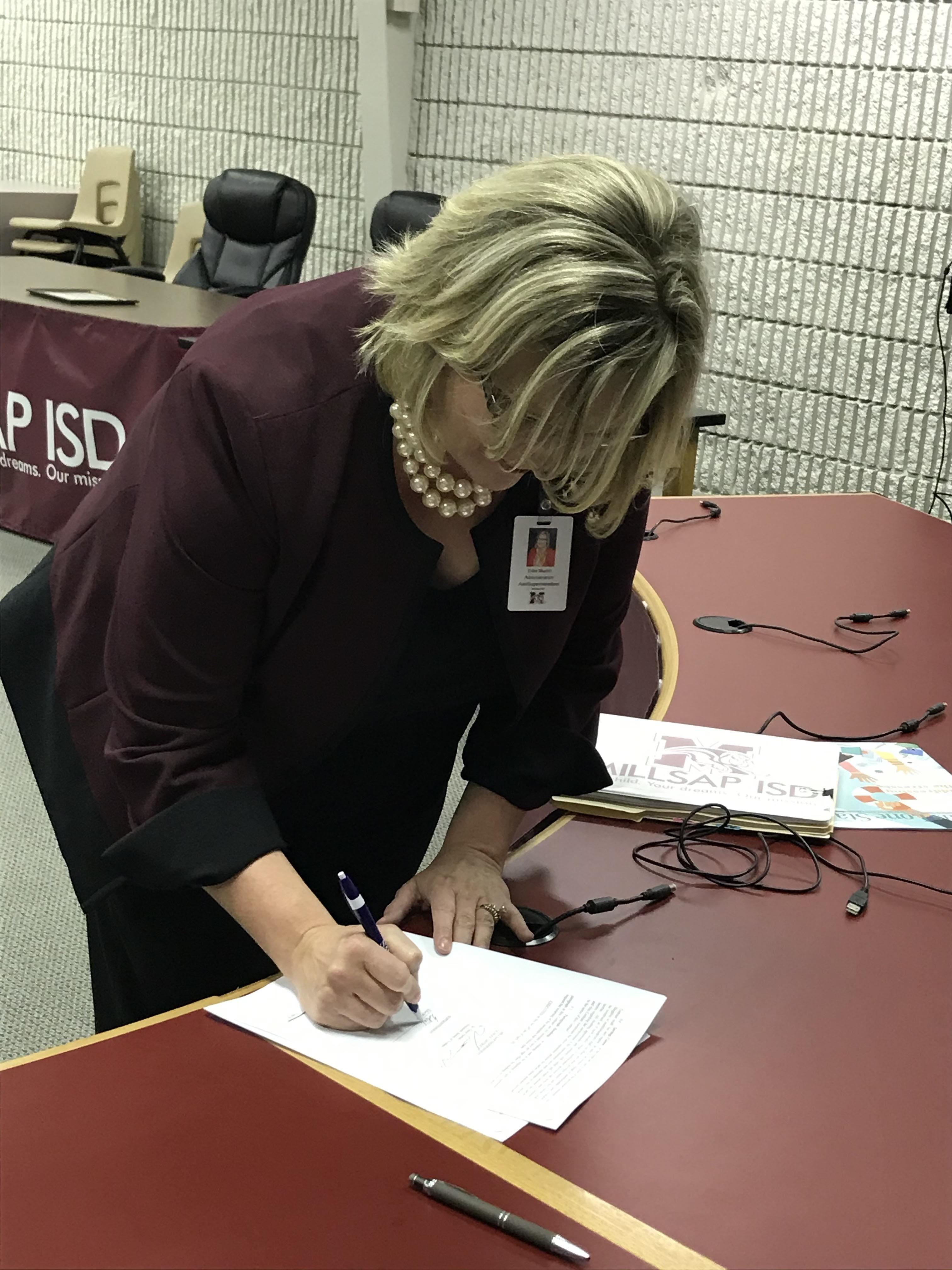 Mrs. Martin Signs Her Contract 